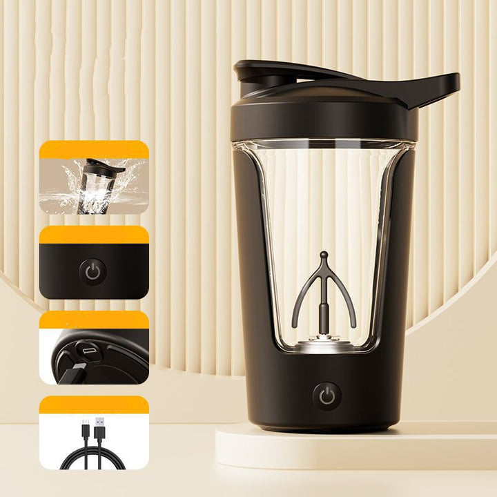 Black portable blender with clear container on a beige background